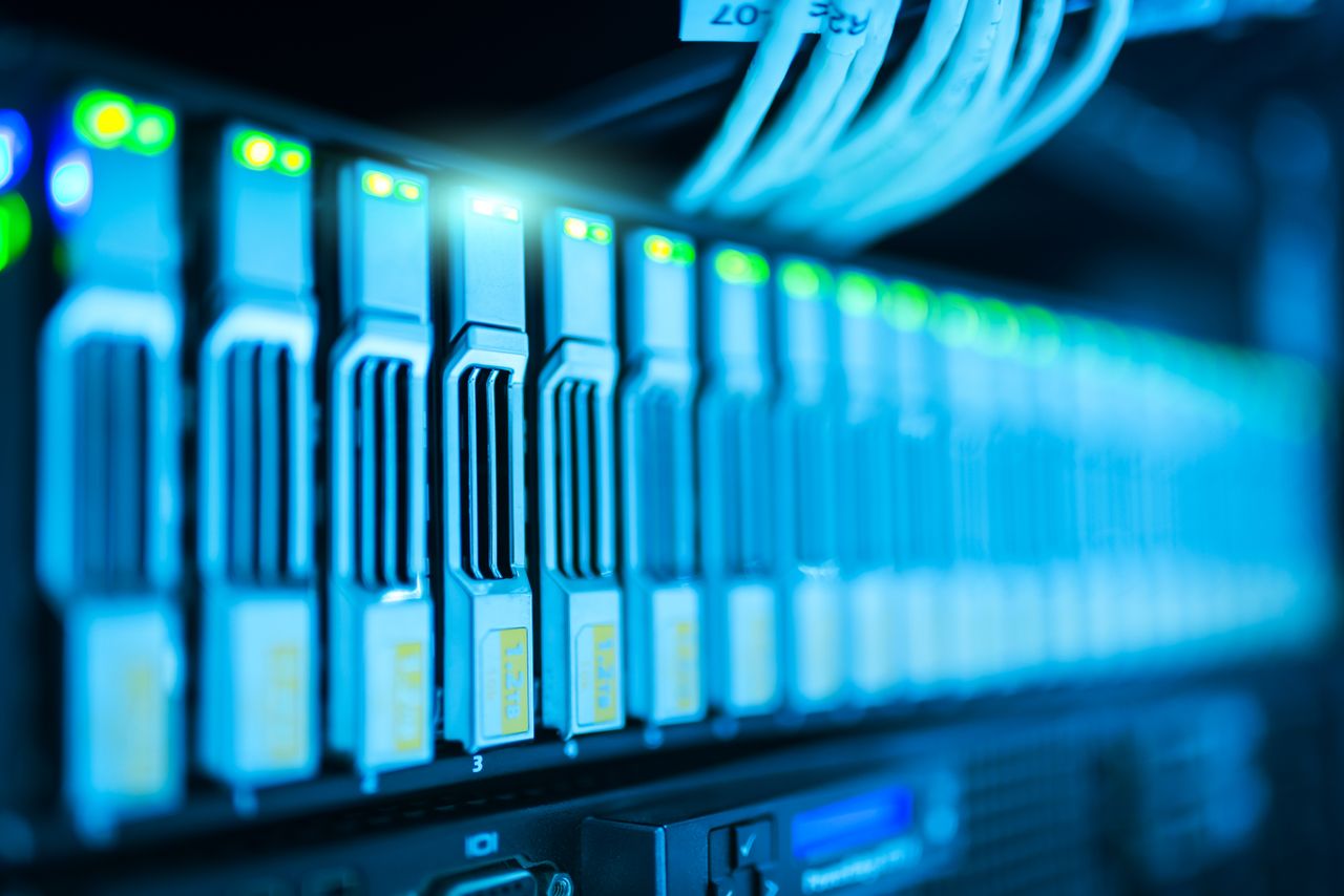 about-us Detailed image of a server rack with glowing lights in a modern data center.